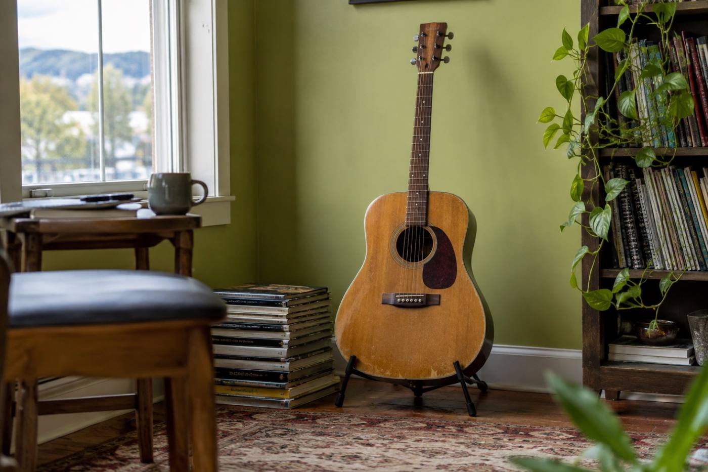 An acoustic guitar resting on a stand in a teaching studio